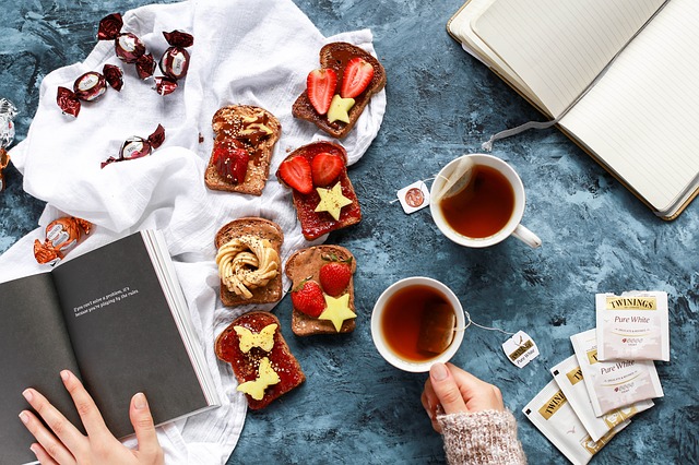 a table with food, coffee, diary and a book