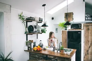 a woman on a desk driking something. graphic used for a post on email support jobs work from home