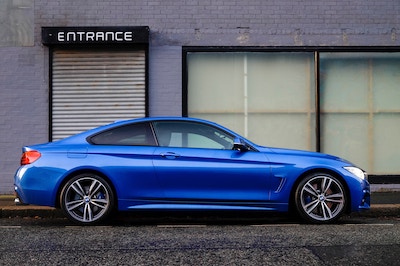 a blue car on the street