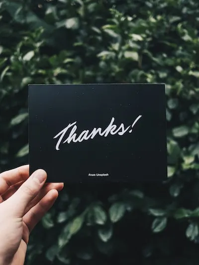 how to thank you for cash gifts - hand holding a card thank says thanks