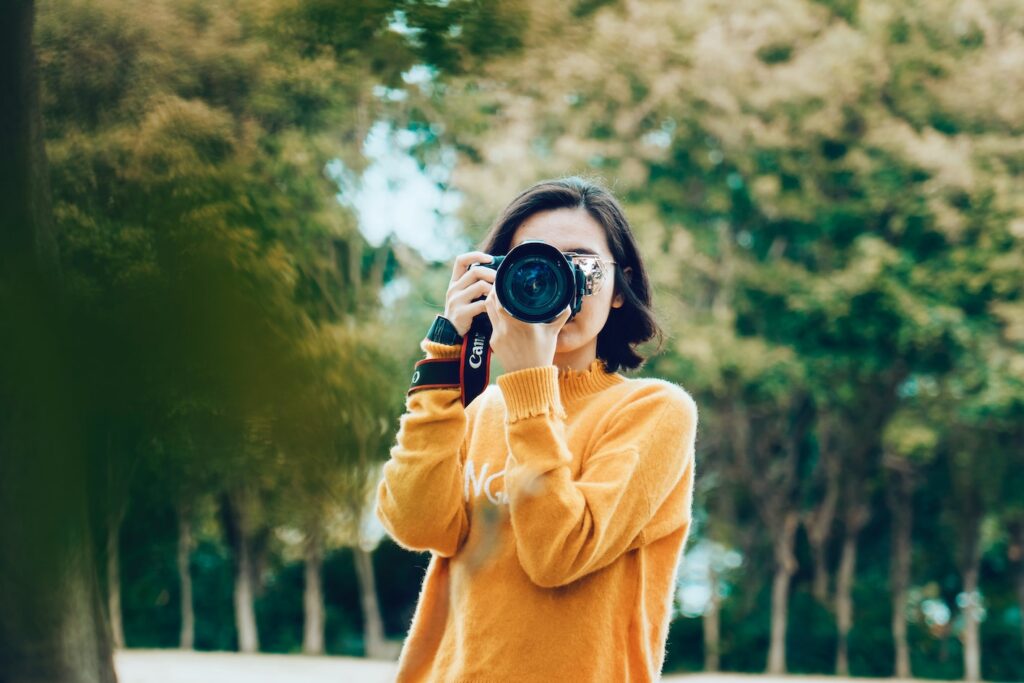 woman clicking picture. graphics for post on apps to sell photos online. 