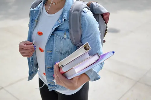 things to sell at school - blog graphic - girl walking to school with books in hand