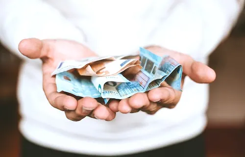 Money in mans hand - blog post graphic for free paypal money instantly