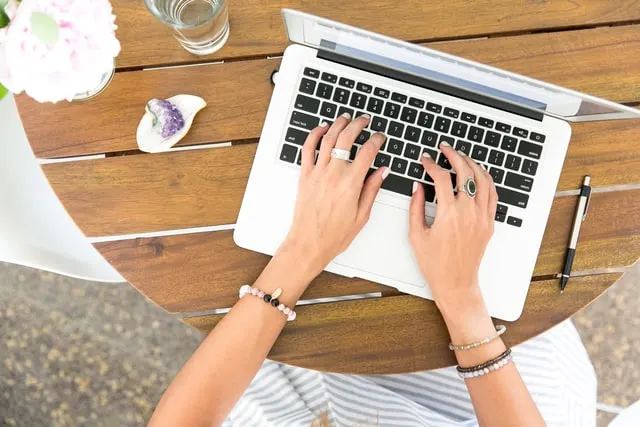 In this image a lady is working on a laptop. Image used for a post on what must an entrepreneur assume when starting a business