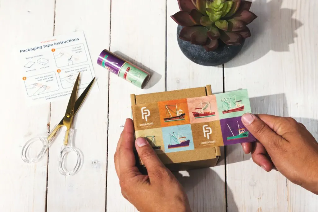 In this image someone is preparing a package to ship.