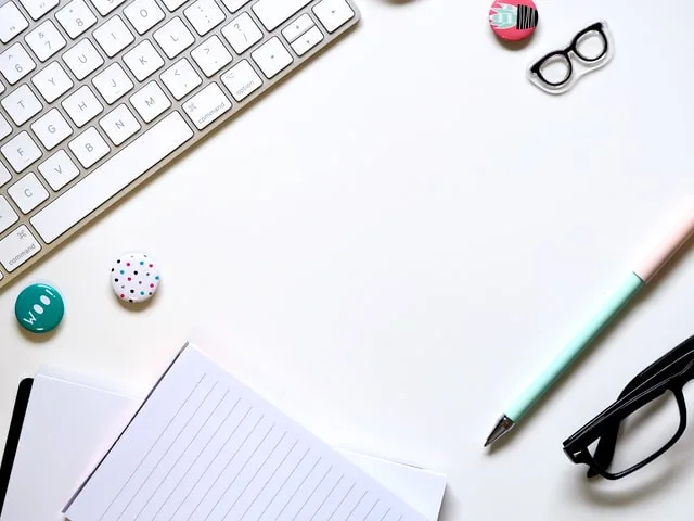 This image includes a notebook, keypad next to a pencil and some buttons.