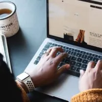 a man typing something on his laptop