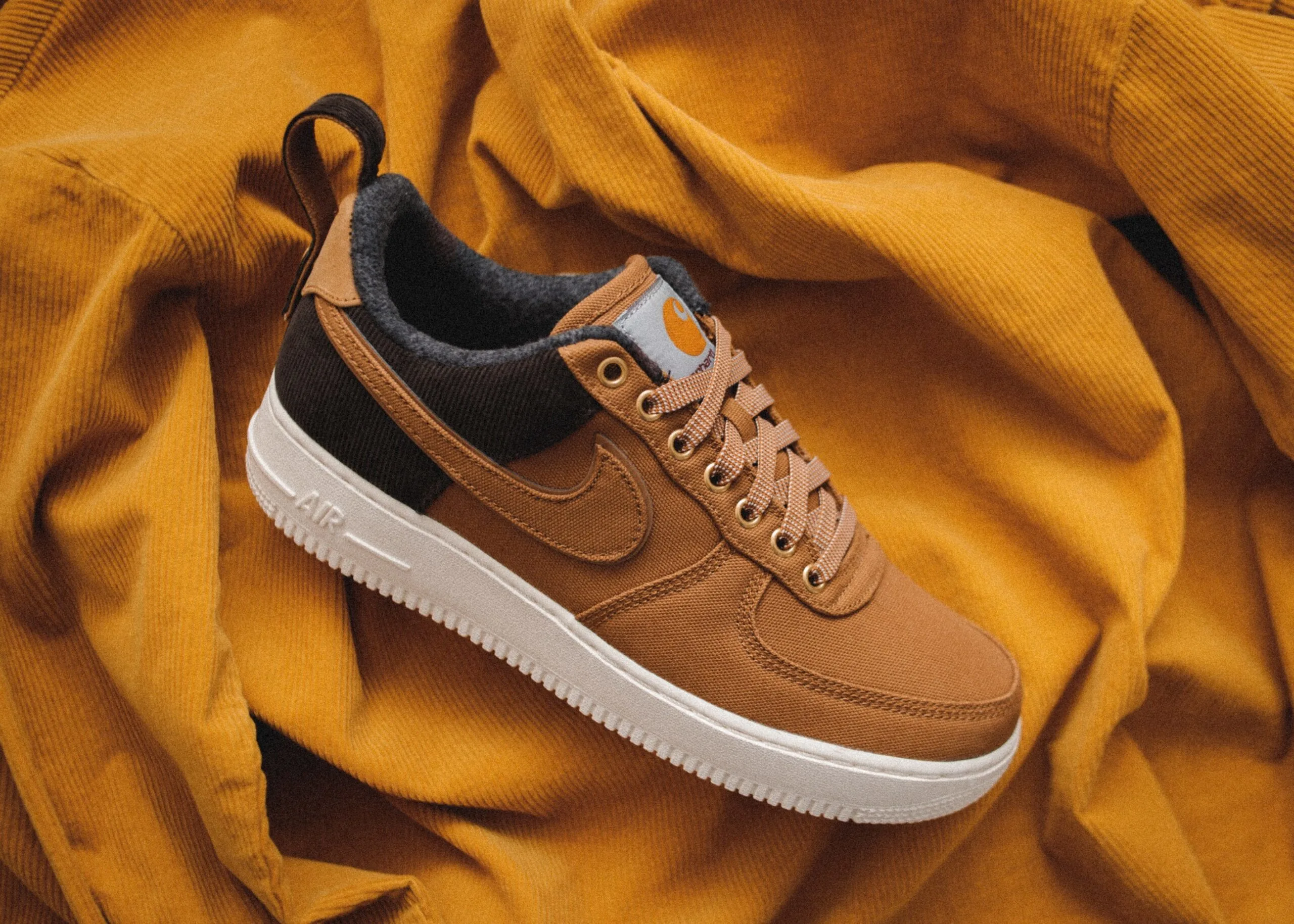 nike shoes on a mustard cloth
