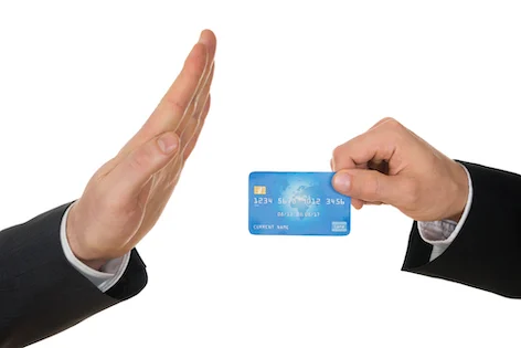 Close-up Of A Businessman's Hand Avoiding Credit Card Over White Background