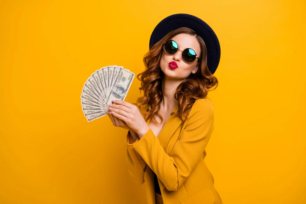 Close up photo beautiful she her lady abroad vacation traveler red allure kiss buy present gift fan usa bucks sale discount high social status wear specs formal-wear isolated yellow bright background.