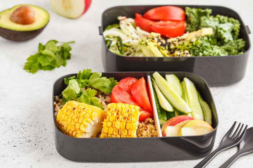 Healthy meal prep containers with quinoa, avocado, corn, zucchini noodles and kale. Takeaway food. White background, top view.