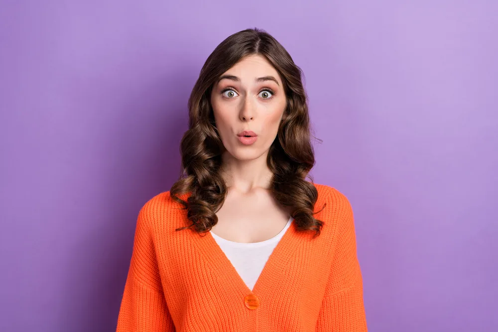 Photo portrait of crazy excited funny woman pouted lips impressed reaction unexpected cheap price clothes sale isolated on purple color background.