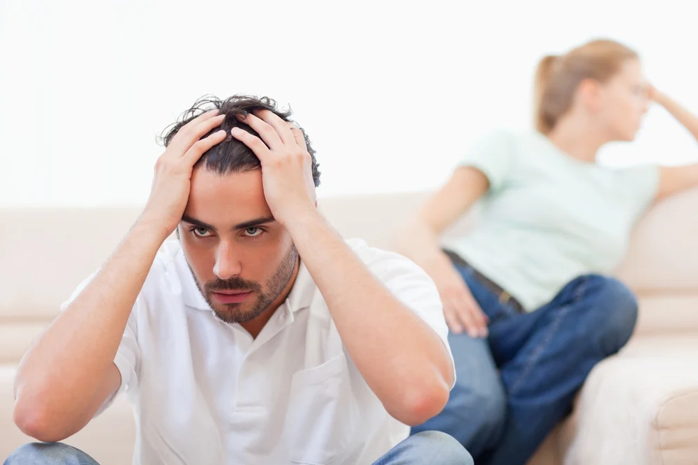 Angry couple mad at each other in their living room