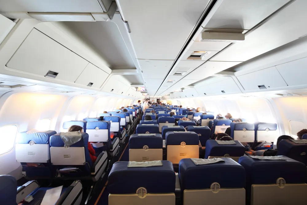 airplane cabin with passengers general view