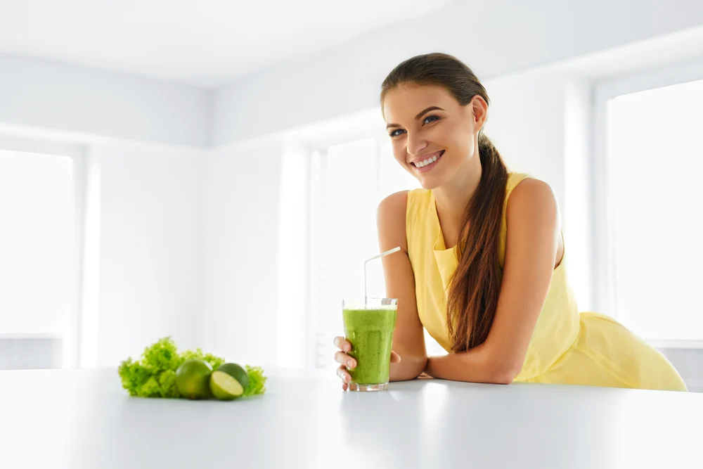 Healthy Meal. Happy Beautiful Smiling Woman Drinking Green Detox Vegetable Smoothie. Healthy Lifestyle, Food And Eating. Drink Juice. Diet, Health And Beauty Concept.