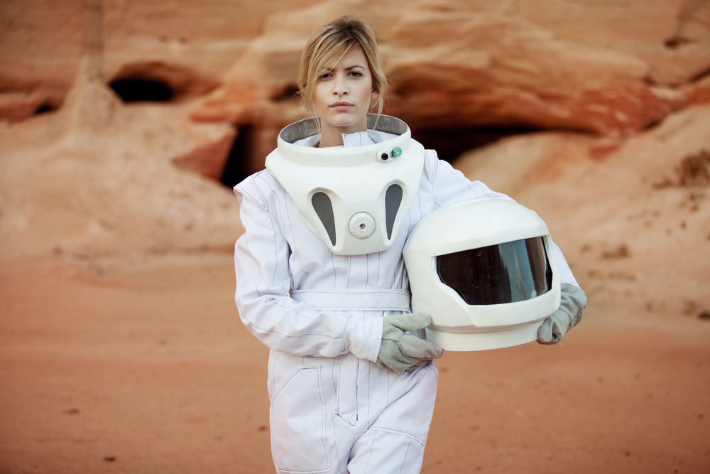 futuristic astronaut on another planet, sandy red planet