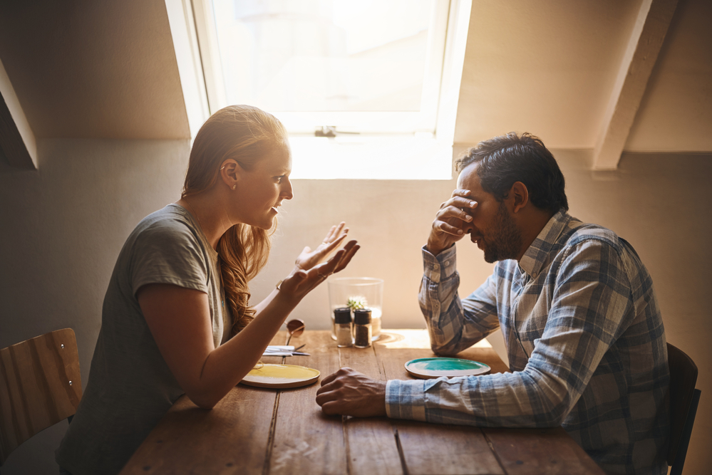 Upset couple, argument and disagreement on date in discussion, fighting or breakup at restaurant. Woman talking to cheating man at dinner table in conflict, problem or affair in conversation at cafe.
