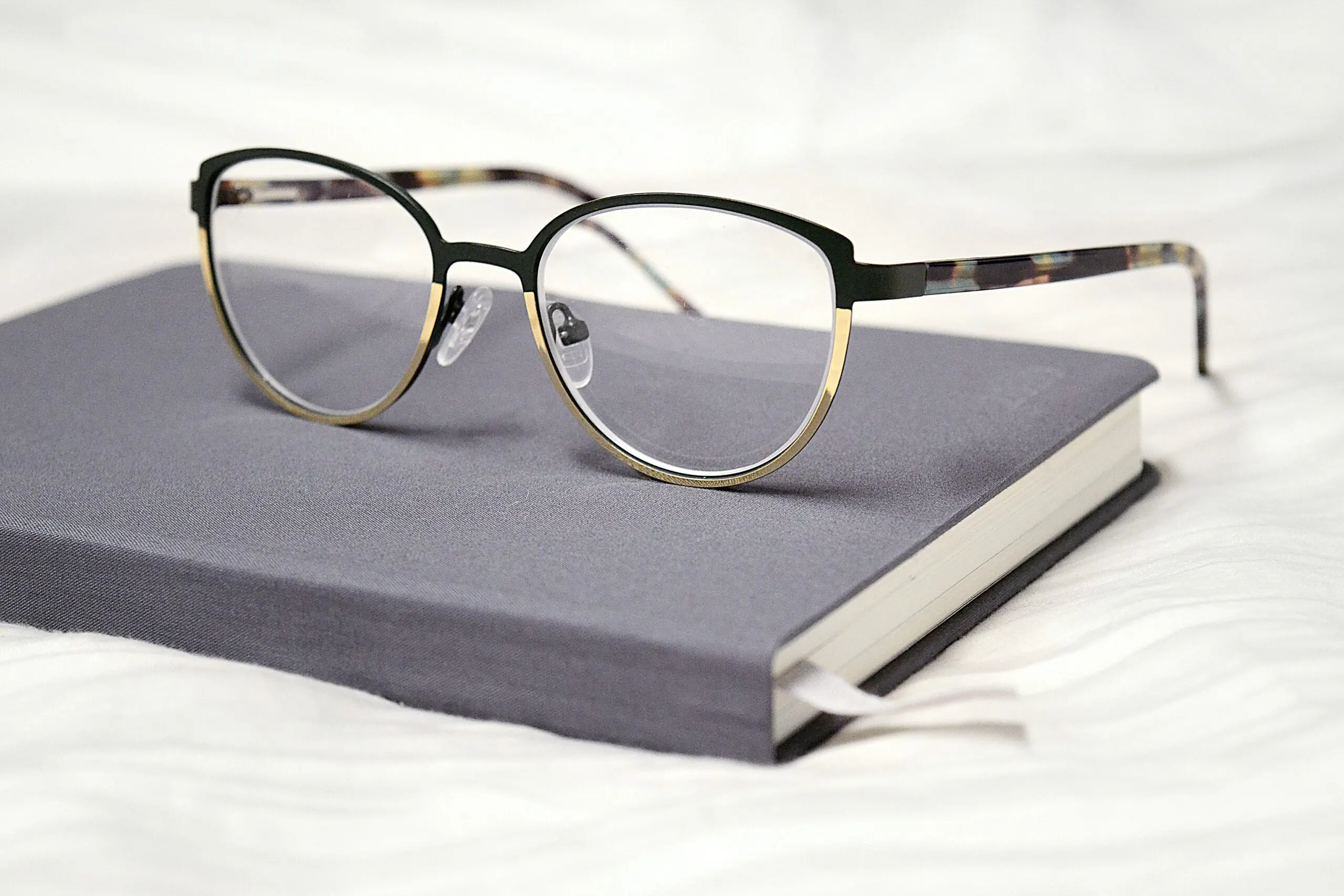 a reading glasses kept upon a book