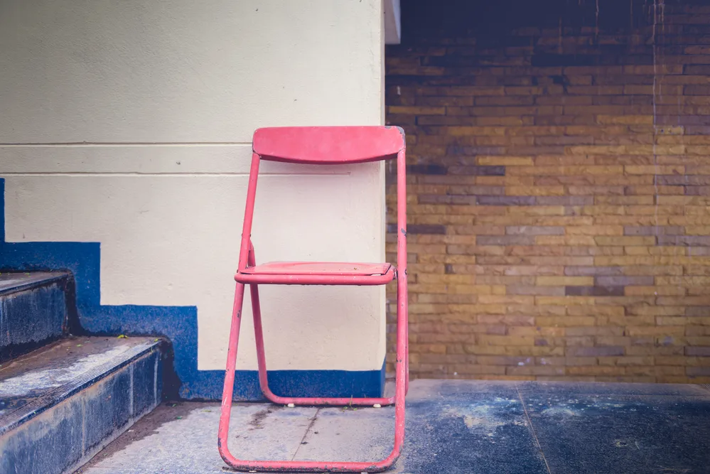 Vintage folding chair and old walls. vintage tone color