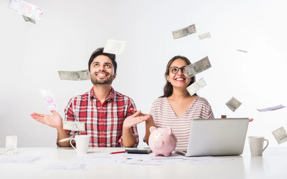 Focused,Indian,Young,Couple,Accounting,,Calculating,Bills,,Discussing,Planning,Budget