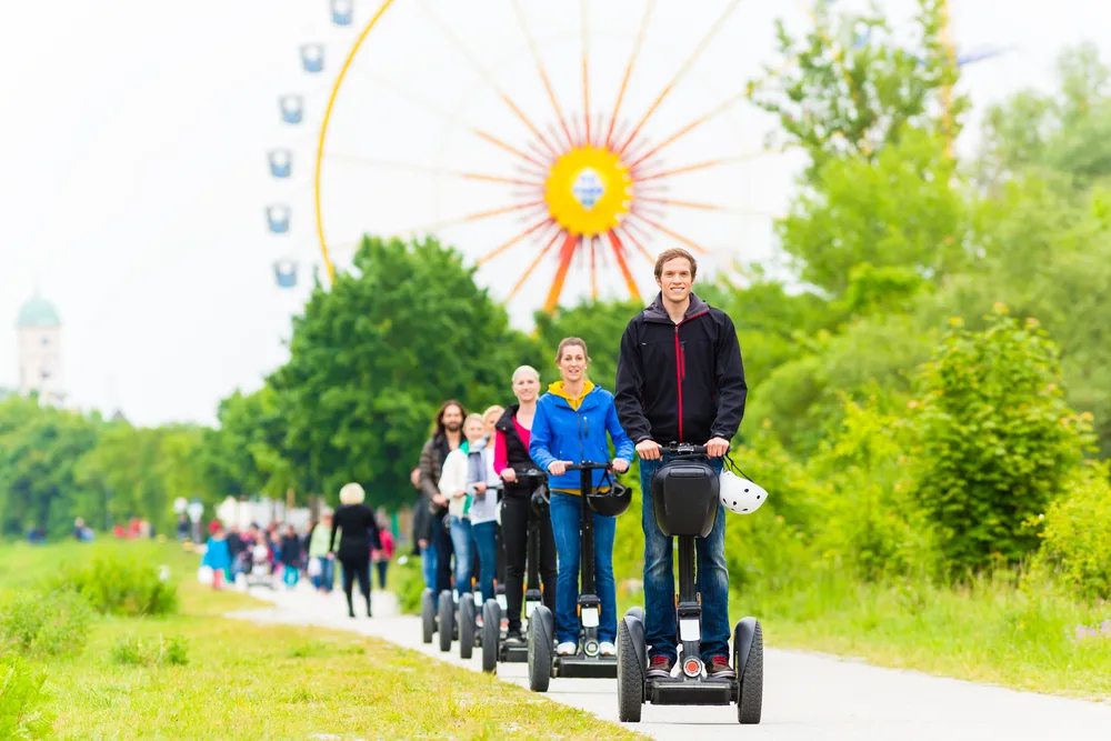 Tourist group having guided Segway theme park tour