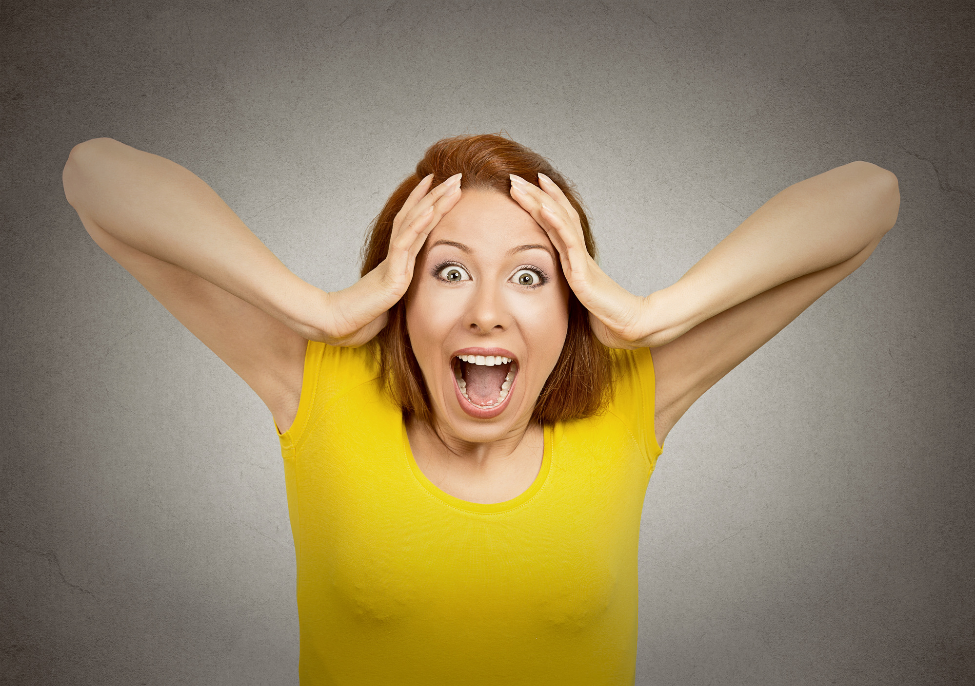 Closeup portrait happy cute young beautiful woman looking excited surprised in full disbelief hands on head it's me? isolated grey wall background. Positive human emotion facial expression feeling