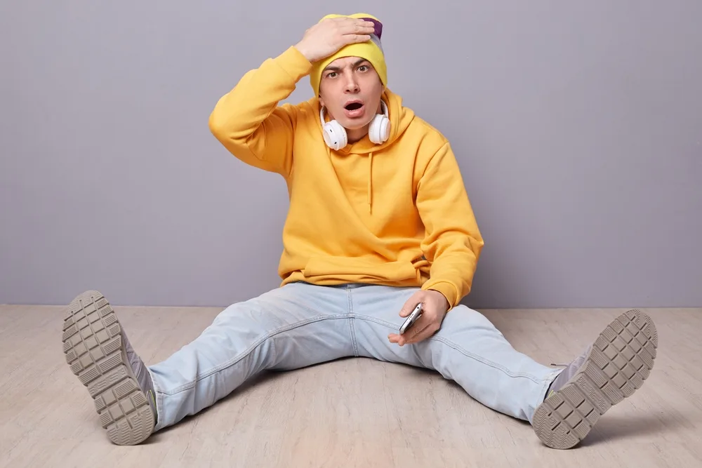 Portrait,Of,Shocked,Disappointed,Man,Wearing,Beanie,Hat,,Yellow,Hoodie