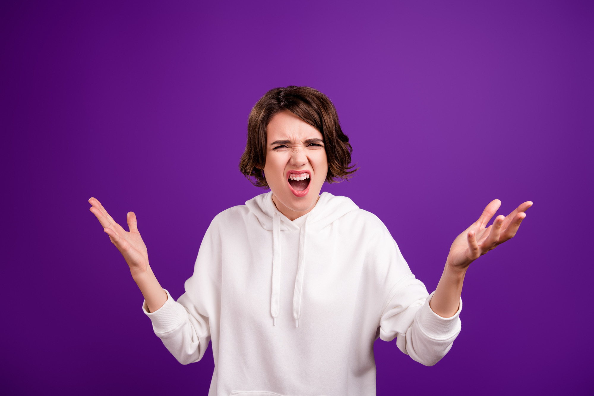 Photo of young unhappy disappointed woman shrug shoulders wtf problem fail isolated on purple color background.