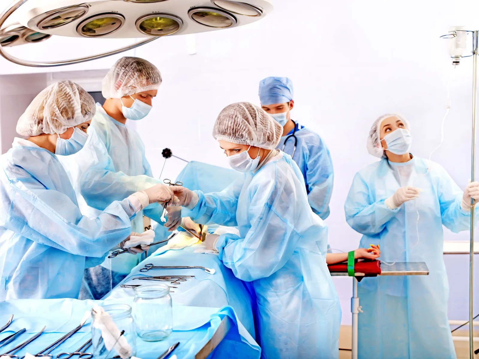 Group people surgeon at work in operating room.