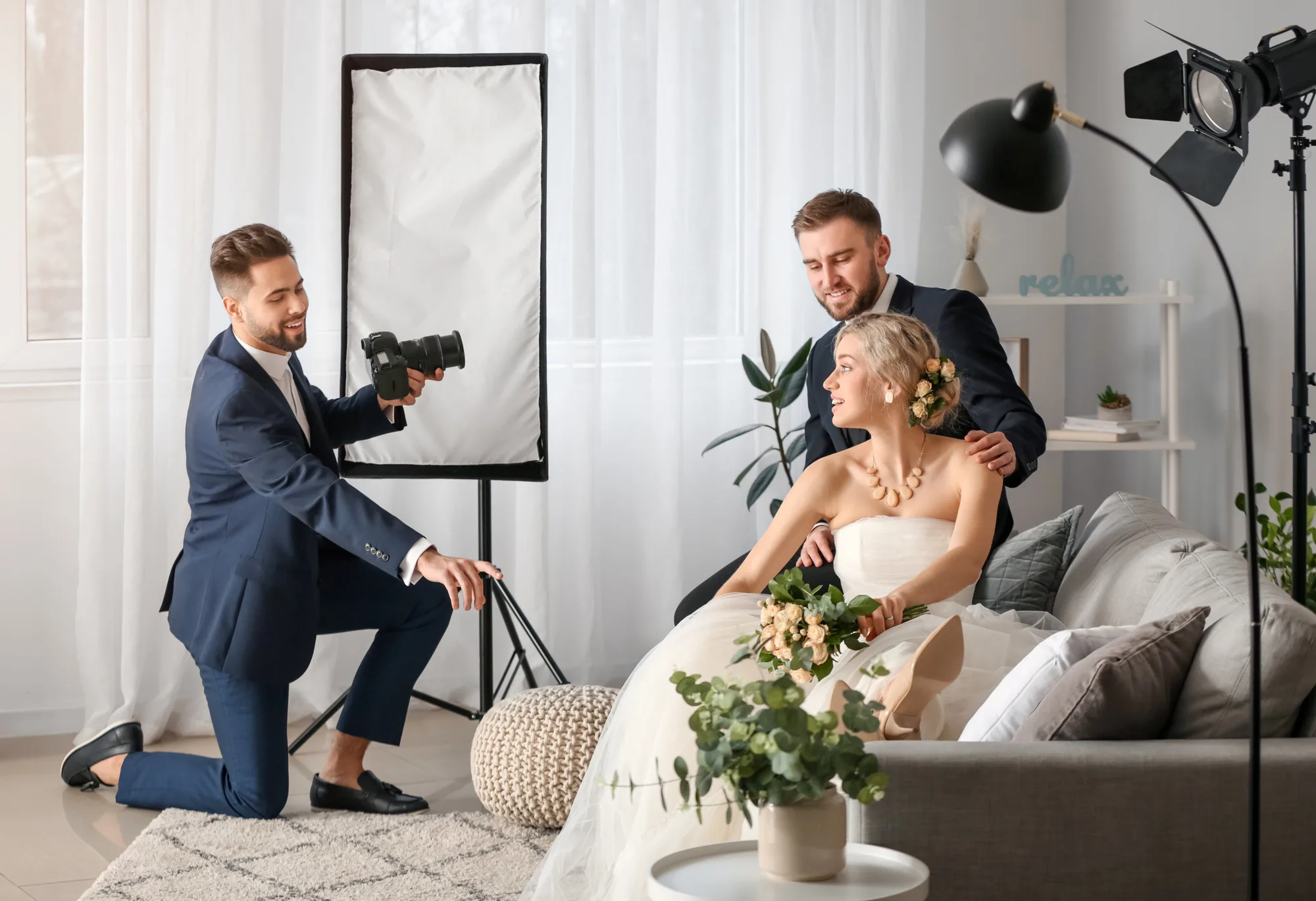 Photographer working with young wedding couple in studio