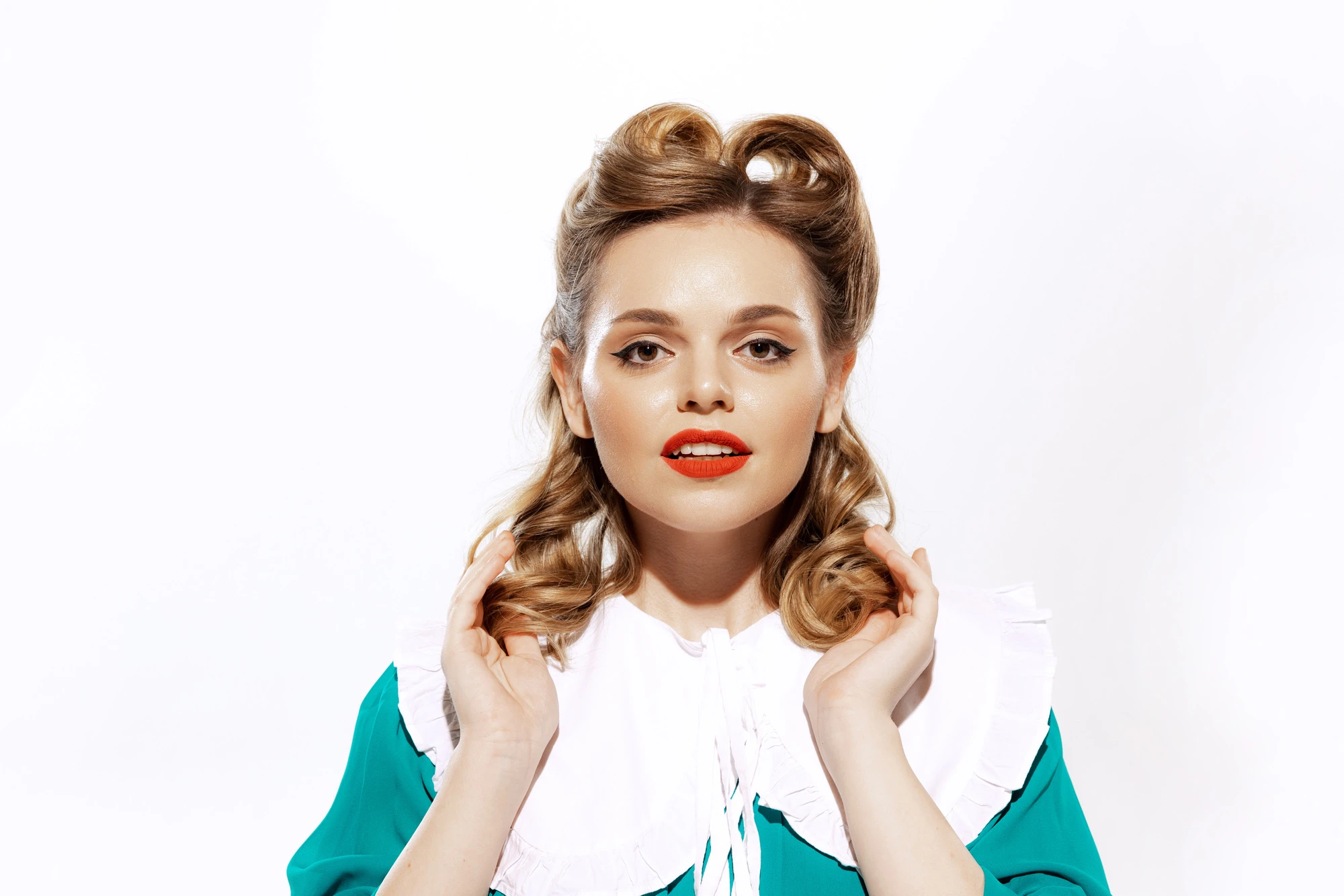 Beauty. Portrait of young happy beautiful woman in retro, 70s, 80s fashion style clothes, vintage outfit looking at camera isolated on white background. Concept of emotions, facial expressions.