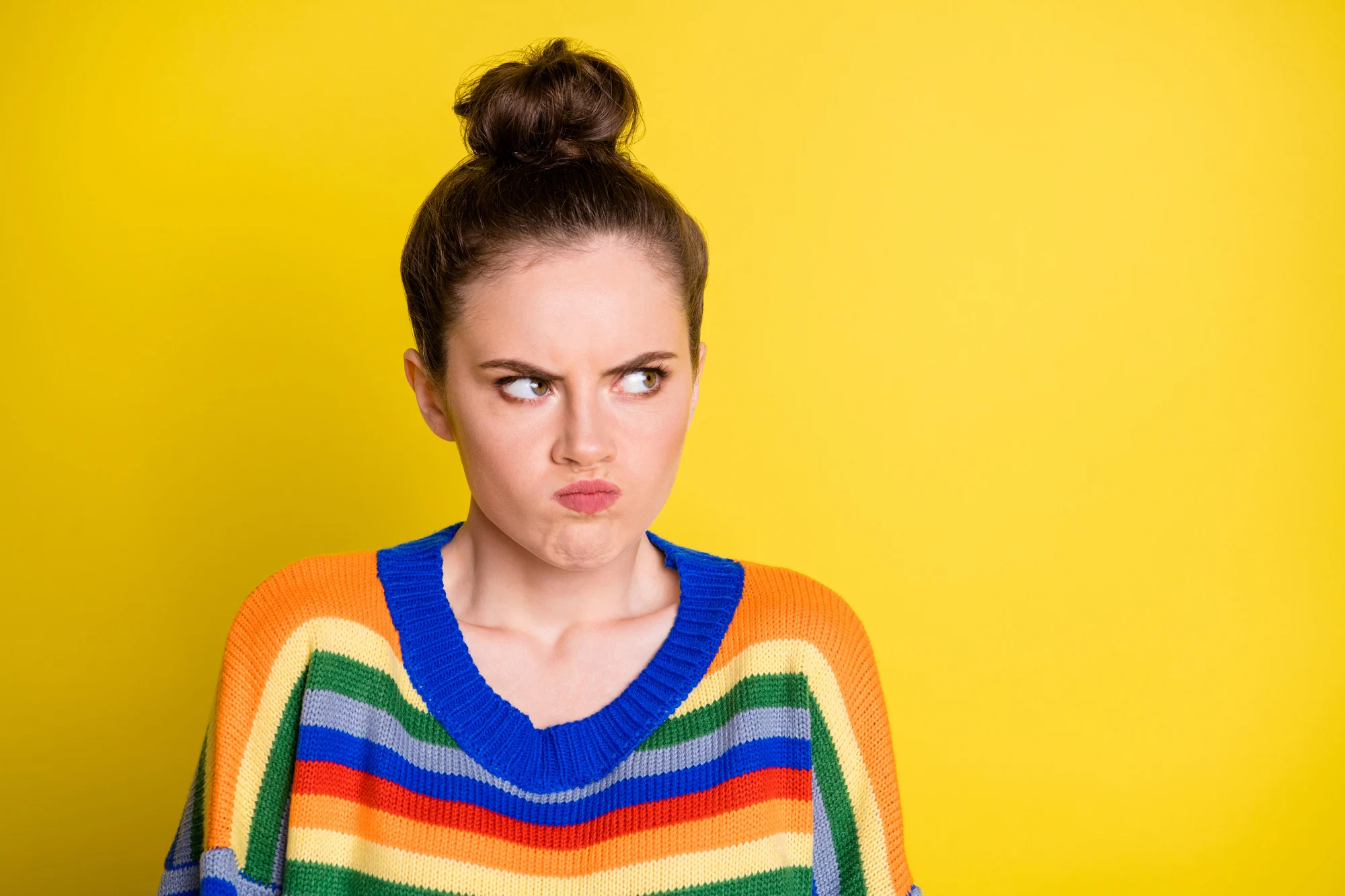 Photo of young girl angry mad aggressive displeased look empty space isolated over yellow color background.