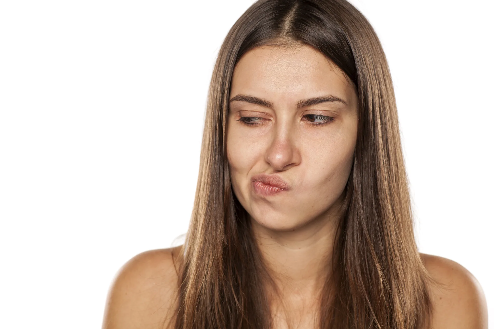 young woman looking with distrust aside