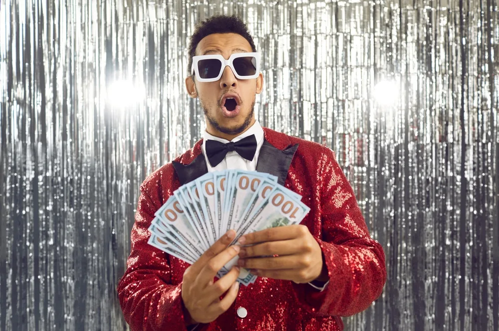 Happy,Wealthy,Ethnic,Winner,Man,In,Shiny,Suit,,Bowtie,And