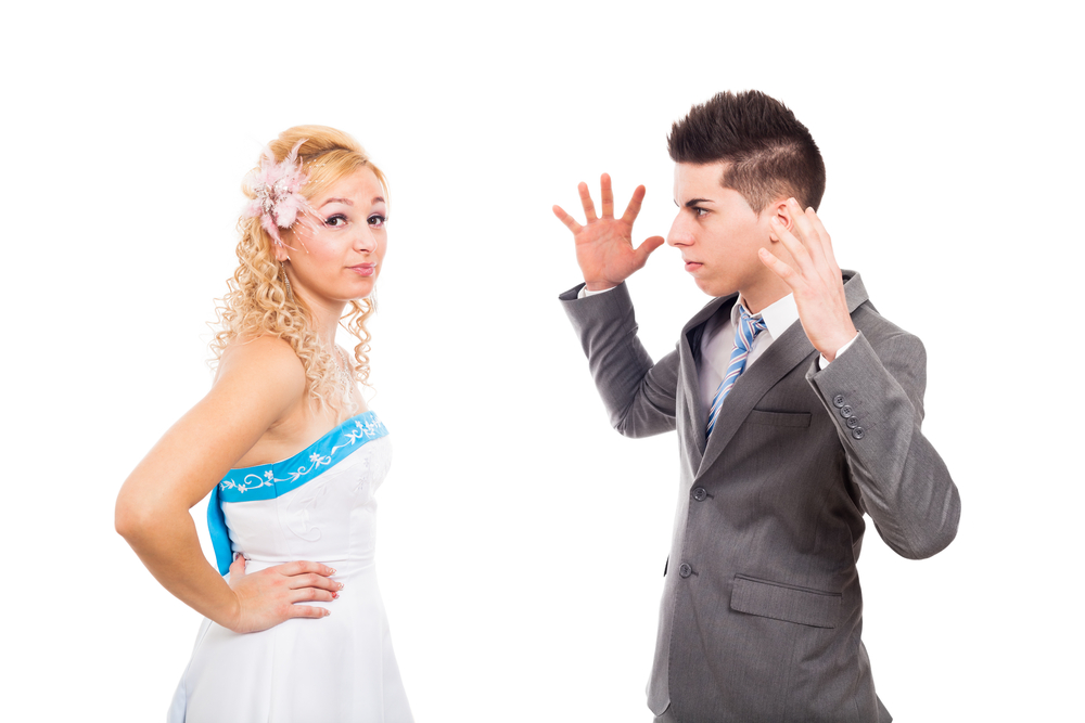Unhappy bride and angry groom arguing, isolated on white background