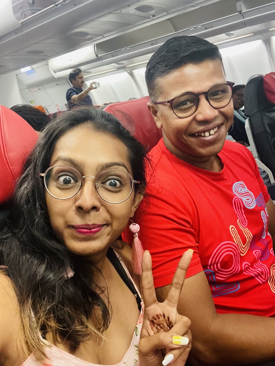 Amit and Chhavi Agarwal, bloggers at Mrs Daaku Studio inside aircraft.