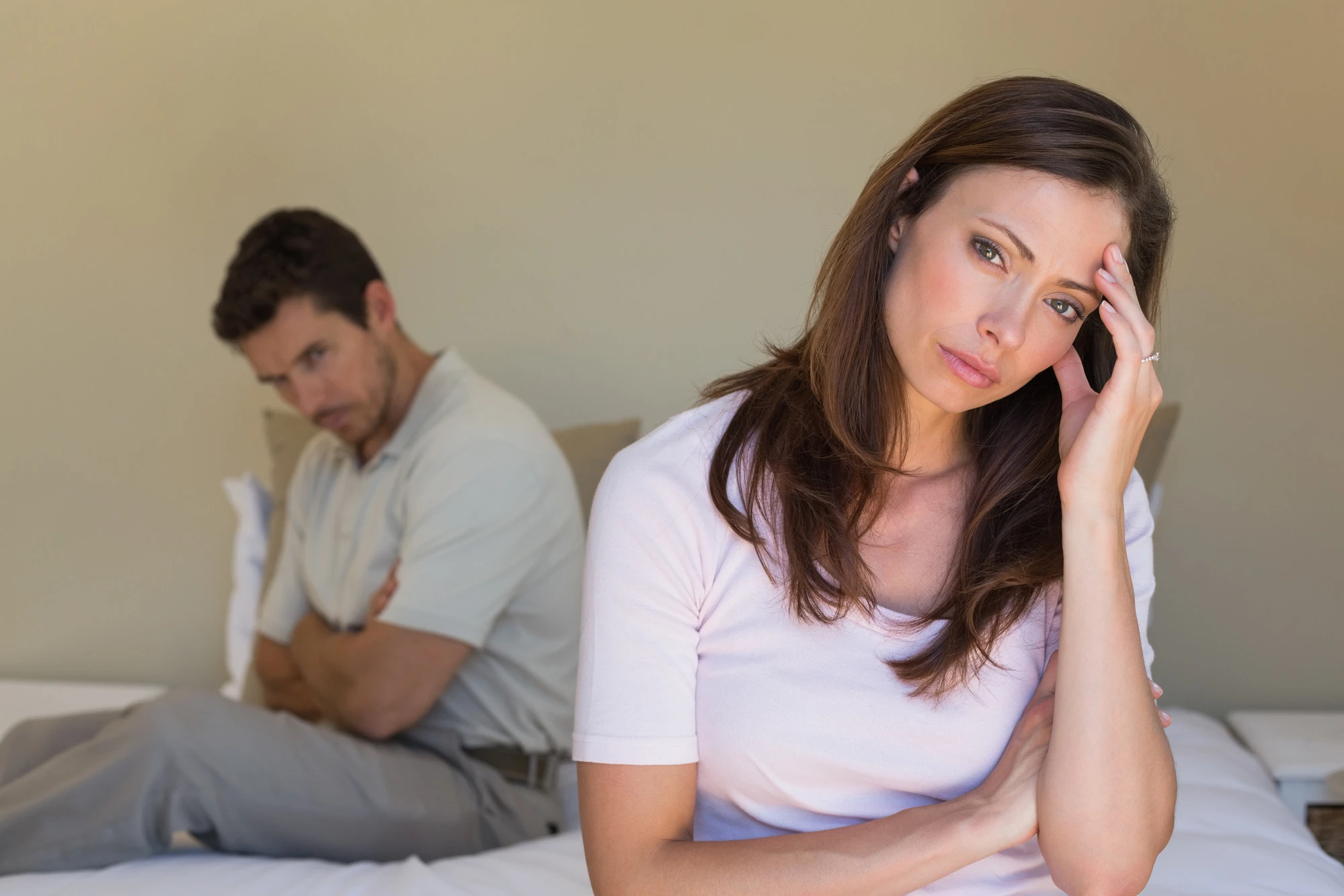 Unhappy couple not talking after an argument in bed at home.