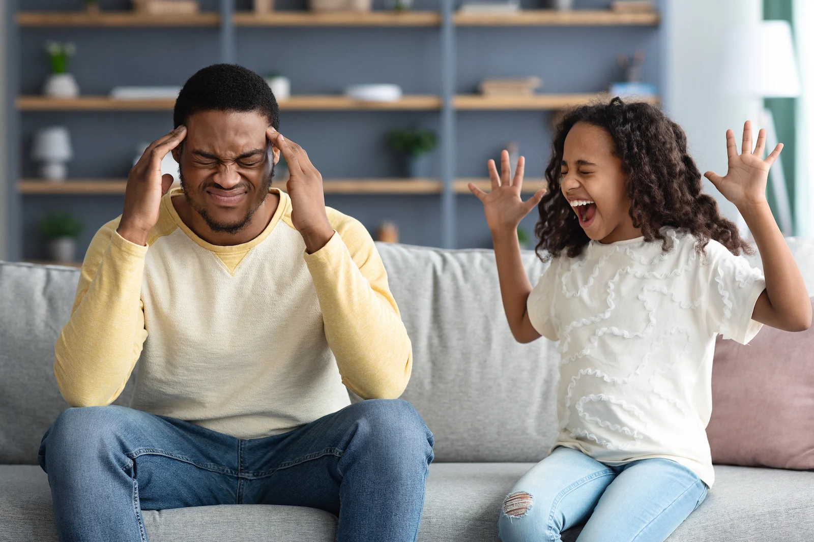 Stubborn noisy african american child girl in screaming at annoyed tired black father, naughty kid daughter with attention deficit yelling, manipulation, family fight, parents and children conflict.