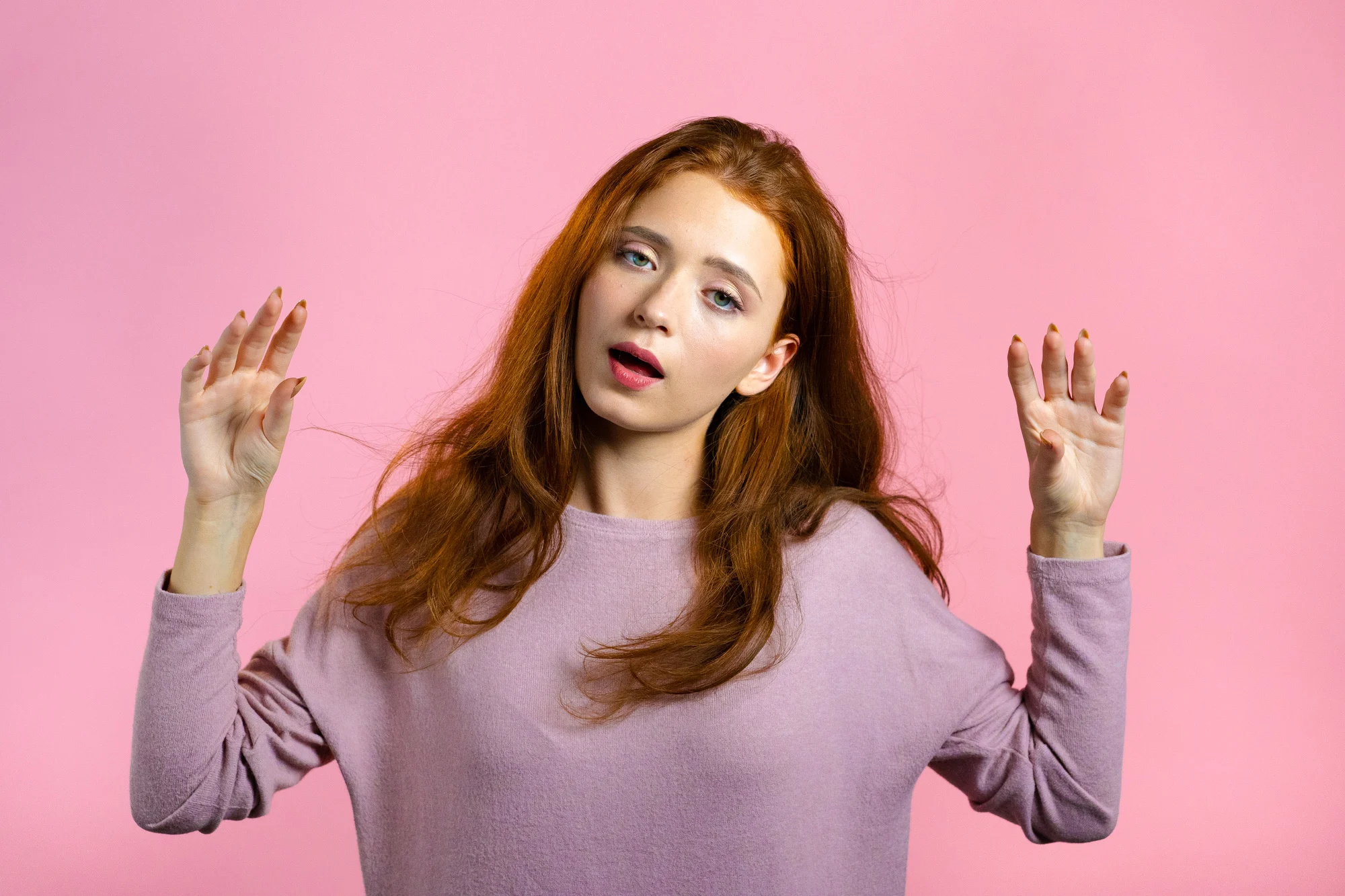 Cute girl showing bla-bla-bla gesture with hands and rolling eyes isolated on pink background. Empty promises, blah concept. Lier.