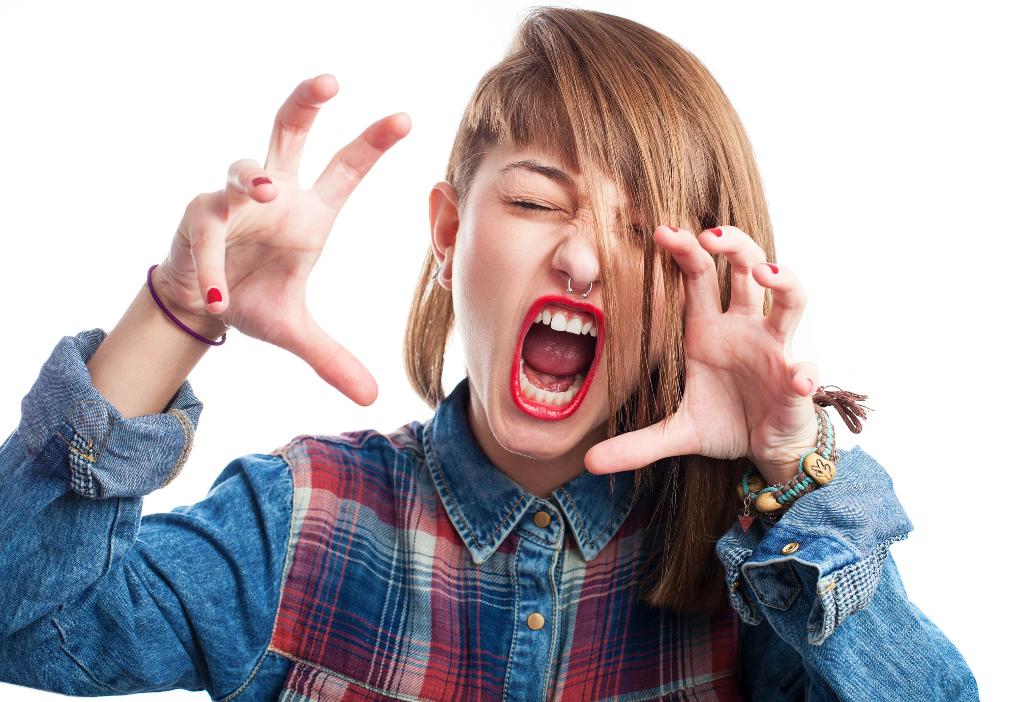 young woman doing an aggressive gesture on white