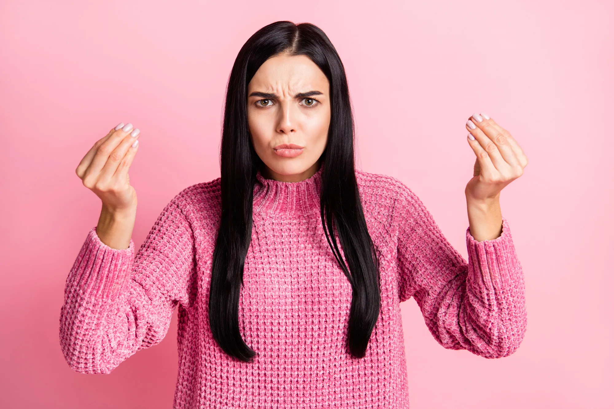 Photo portrait of unhappy girl showing italian hand gesture isolated on pastel pink colored background.
