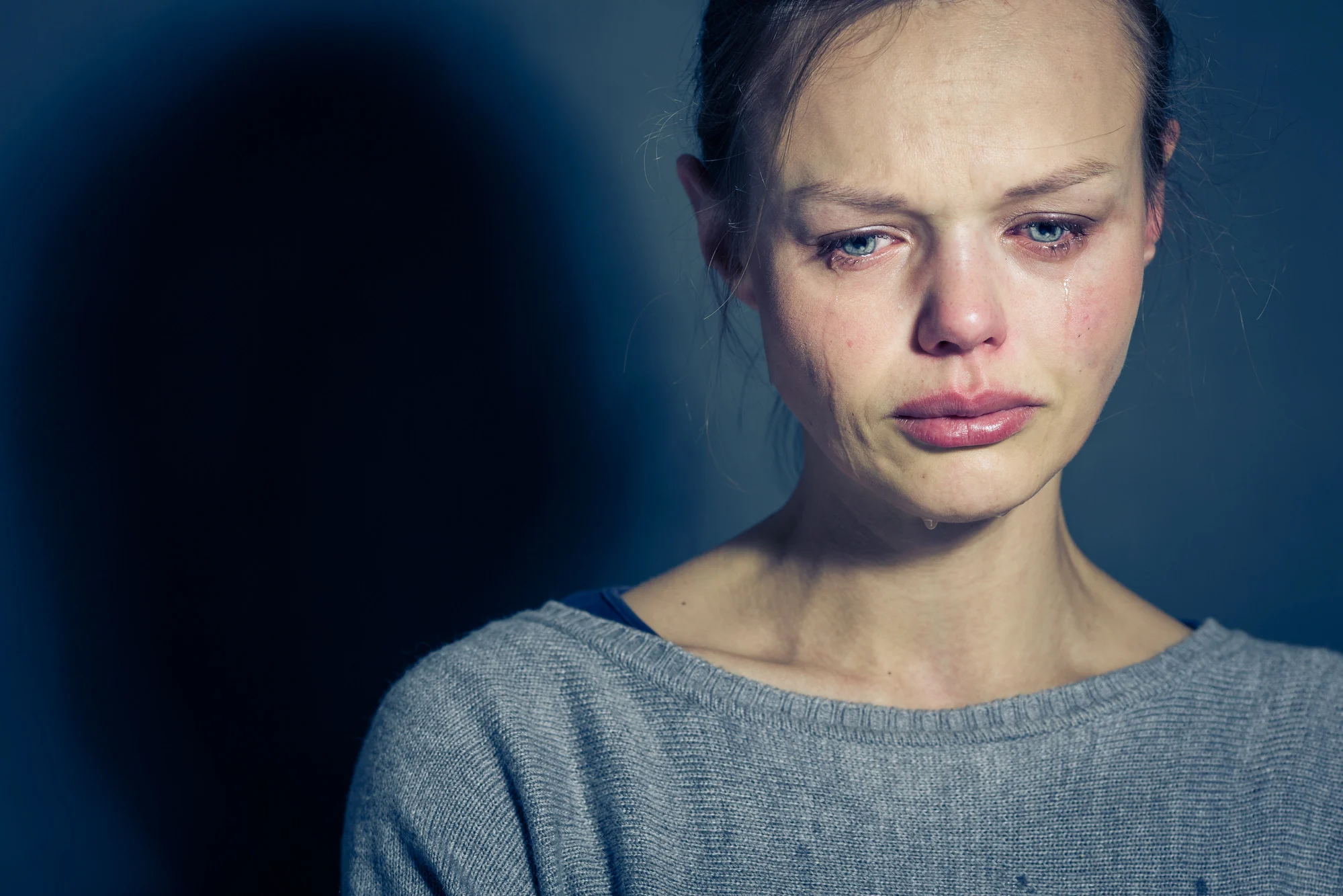 Young woman suffering from severe depression/anxiety/sadness, crying, tears coming from her eyes