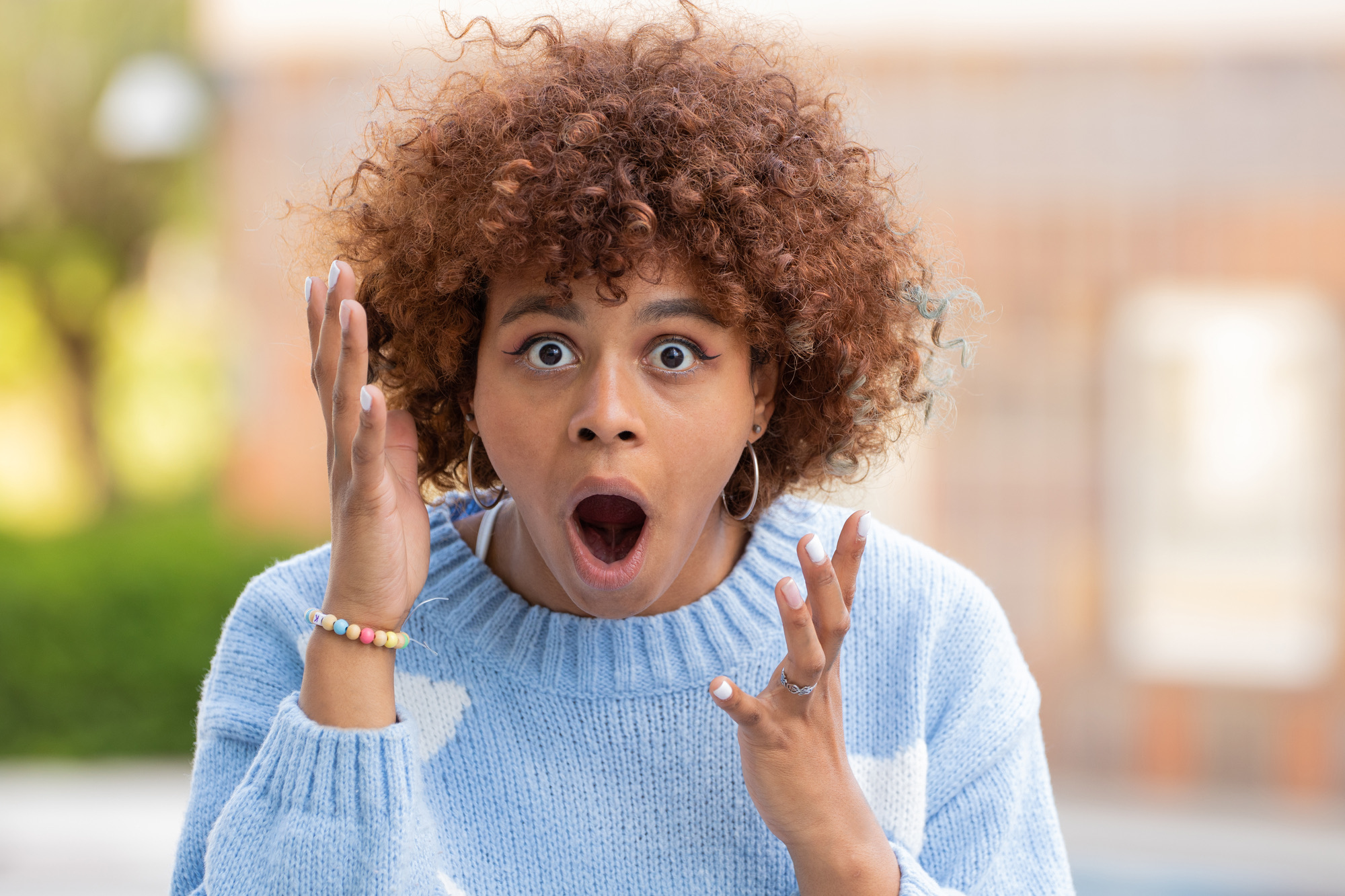 african american girl in the street with surprised expression