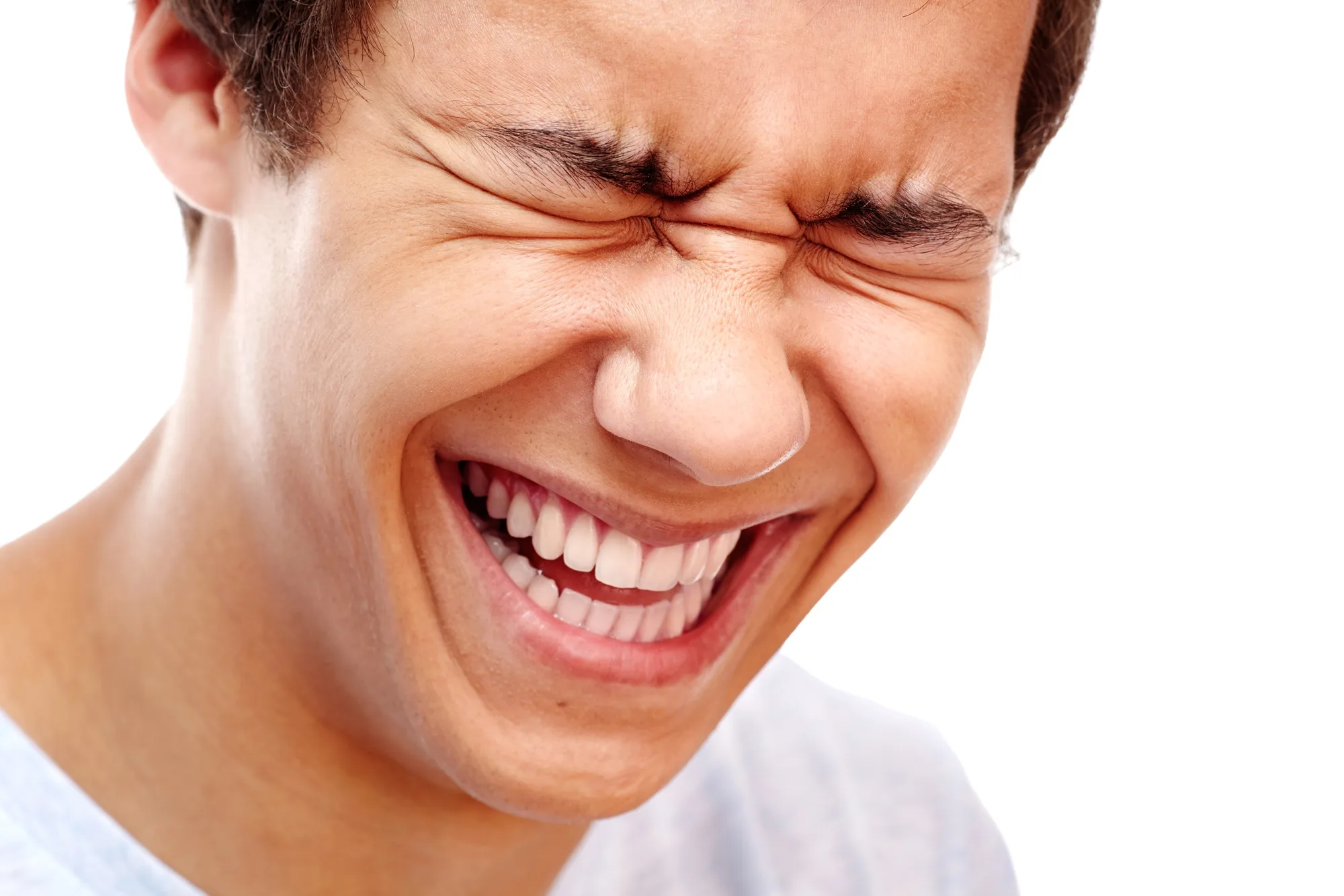 Close-up portrait of young man laughing out loud