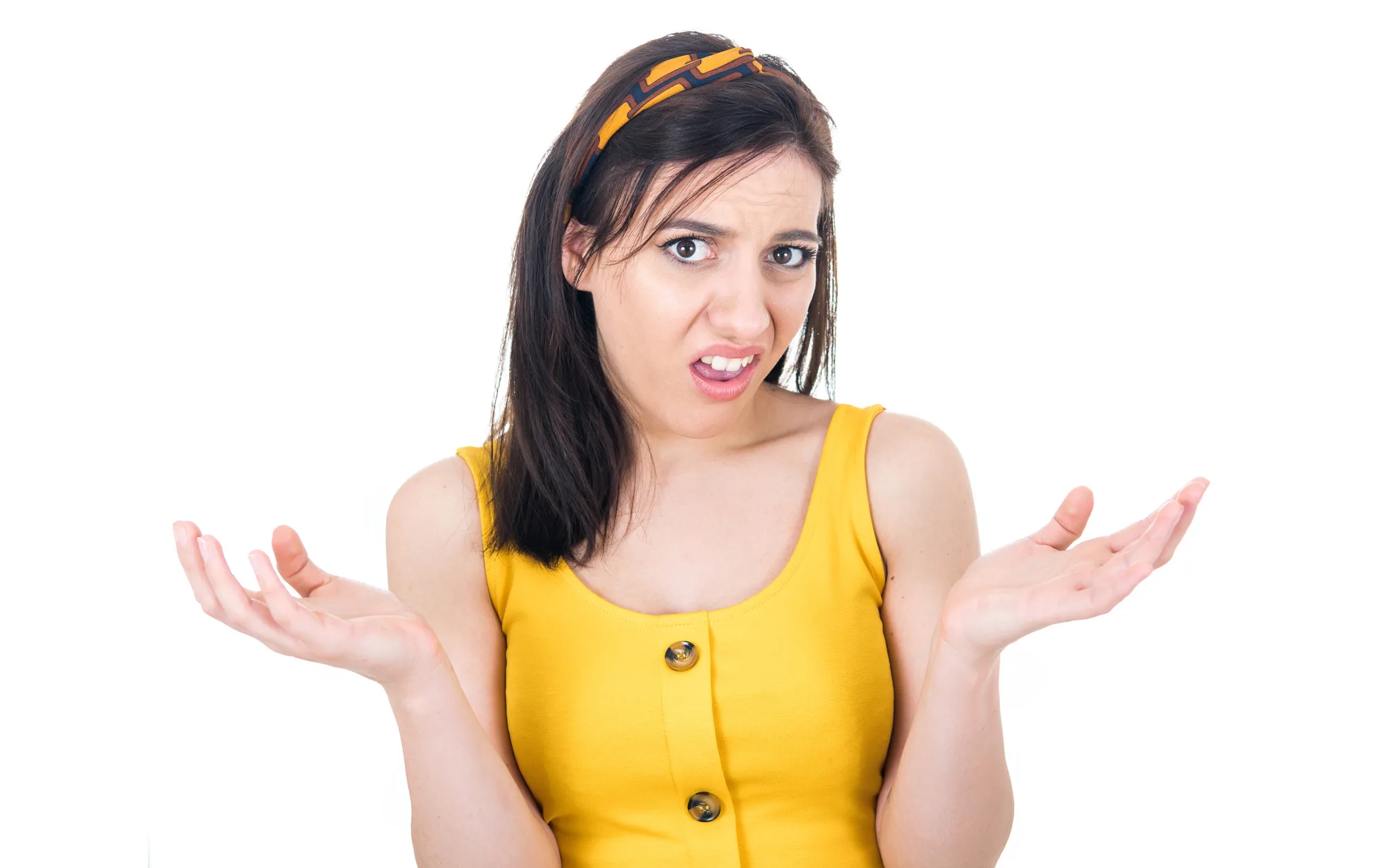 Confused young woman shrugging shoulders, don't know what to say, isolated on white background. Body language. Studio shot