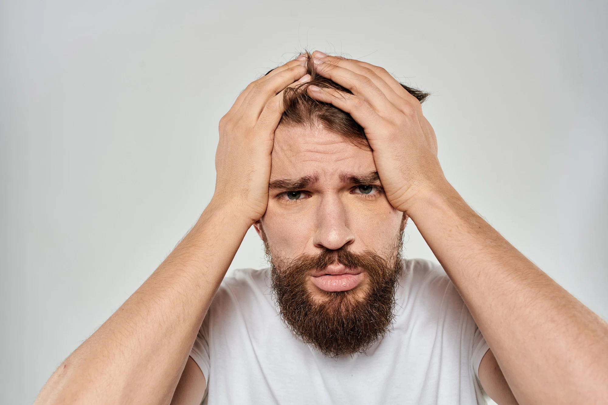 emotional bearded man close-up facial expression studio lifestyle