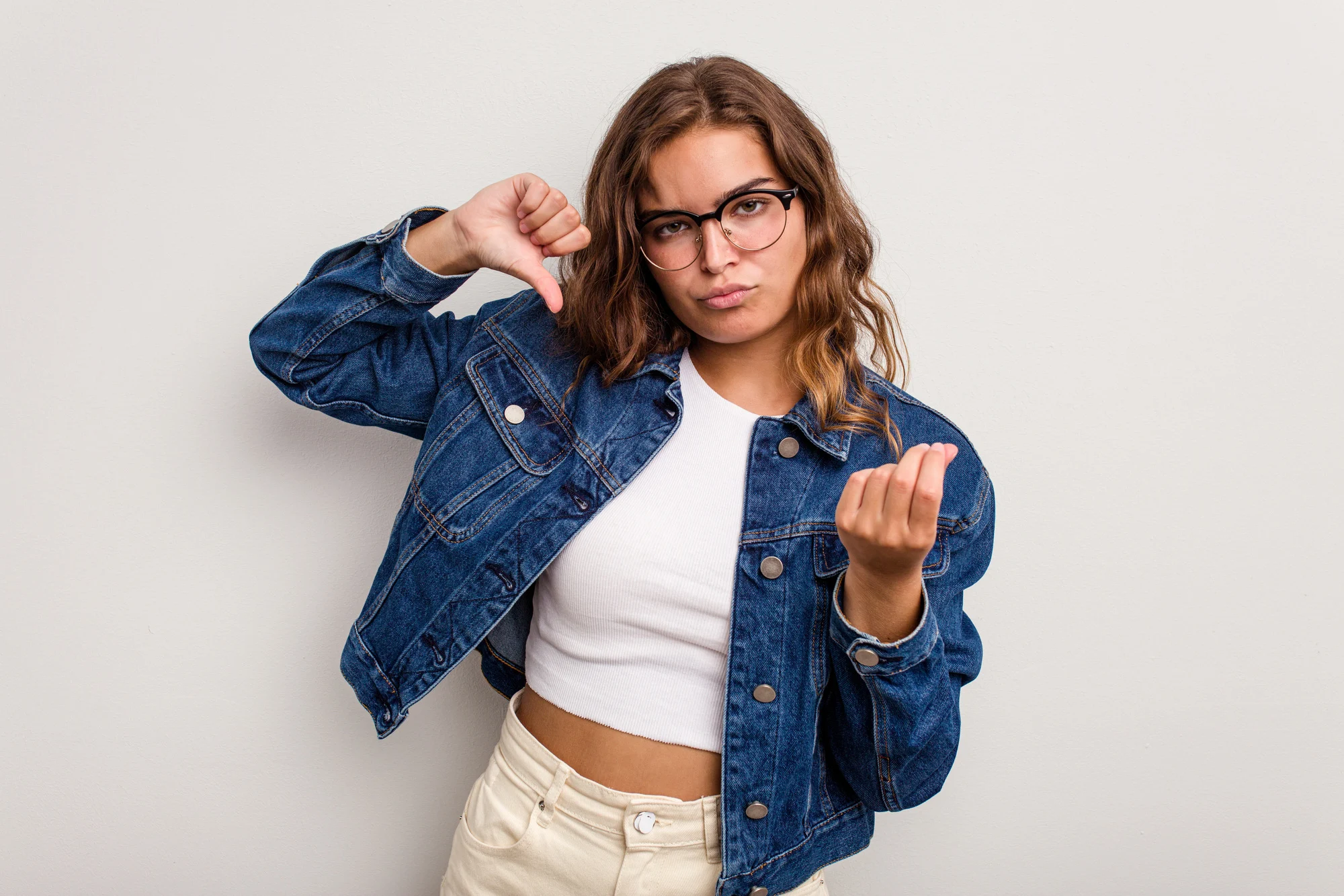 Young caucasian woman isolated on blue background showing that she has no money.