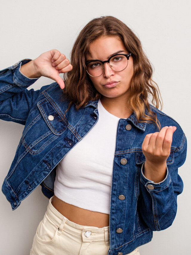 Young caucasian woman isolated on blue background showing that she has no money.