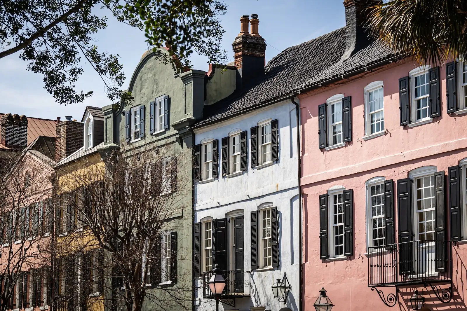 The home along Rainbow Row in Charleston, South Carolina. These Georgian style homes are brightly painted in direct sunlight.